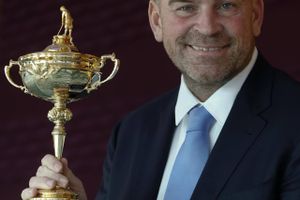 The newly appointed 2018 Europe Ryder Cup captain Thomas Bjorn holds the Ryder Cup as he poses for photographs at a hotel near Heathrow Airport, London during a media event Wednesday, Dec., 7, 2016. (AP Photo/Alastair Grant)