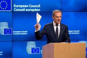 European Council President Donald Tusk holds up the document from the UK during a media conference at the Europa building in Brussels on Wednesday, March 29, 2017. Tusk has received a letter from British Prime Minister Theresa May, invoking Article 50 of the bloc's key treaty, the formal start of exit negotiations. (AP Photo/Virginia Mayo)