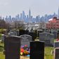 View of gravestones from a cemetery with the Manhattan skyline in the background on April 07, 2020 in Brooklyn, New York. (Photo by Angela Weiss / AFP)