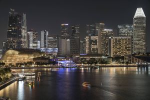Buildings in the central business district at night in Singapore, on July 12, 2019. Photo: Ore Huiying/Bloomberg