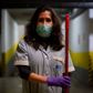 Cecilia Alvarez Velasco, 47, from Ecuador, poses for a picture as she works cleaning in a condominium residence in Barcelona on April 9, 2020 during a national lockdown to prevent the spread of the COVID-19 disease. (Photo by Josep LAGO / AFP)