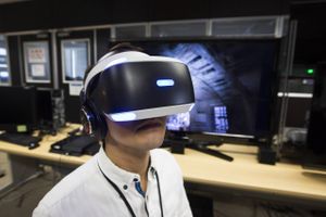 A Capcom Co. employee wearing a Sony Computer Entertainment Inc. PlayStation VR headset in Osaka, Japan, on July 25, 2016. Photo: Tomohiro Ohsumi.