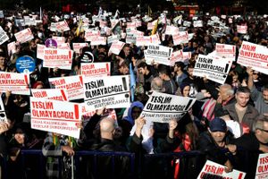 Thousands of people hold placards that read " We will not surrender! " as they stage an anti-government rally, condemning the arrests of opposition journalists, academics and politicians, in Asian side of Istanbul, Sunday, Nov. 20, 2016. (AP Photo/Halit Onur Sandal)