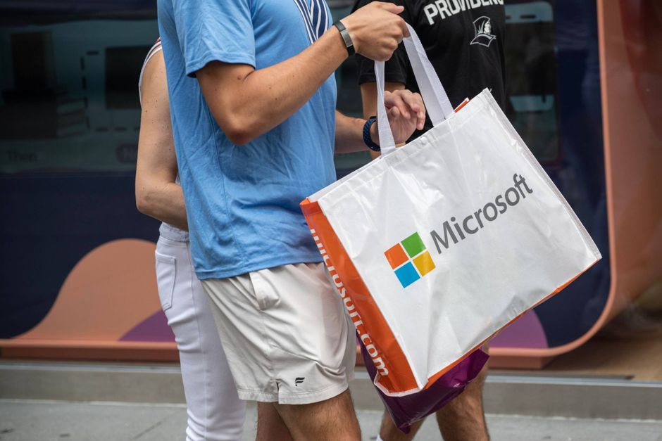 A pedestrian carries a Microsoft shopping bag in New York on June 17. Bloomberg photo by Victor J. Blue.