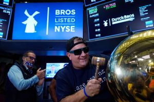 Dutch Bros Coffee Co-founder and Executive Chairman Travis Boersma tosses the gavel after he rang the ceremonial first trade bell on the floor of the New York Stock Exchange, as his companys IPO opens, Wednesday, Sept. 15, 2021. (AP Photo/Richard Drew)
