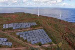 Wind turbines beyond an array of solar panels on the hillside in the Canical district of Madeira, Portugal, on Thursday, Feb. 9, 2023. Renewables are now among the cheapest forms of electricity, especially after an energy crunch and the Ukraine war bolstered gas, oil and coal. Bloomberg photo by Zed Jameson
