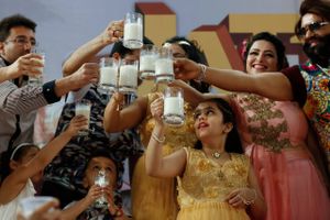 Indian spiritual leader turned actor Gurmeet Ram Rahim, right and others raise a toast with glasses of milk as they hold a ‘Cow Milk Party’ during the premiere of movie ‘Jattu Engineer’ in New Delhi, India, Wednesday, May 17, 2017. The organizers said they were holding the ‘Cow Milk Party’ to appeal against cow slaughter. (AP Photo/Tsering Topgyal)
