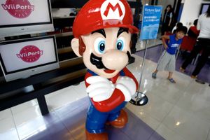 A boy looks at a Nintendo's popular game figure Super Mario at the Japanese game maker's showroom in Tokyo Thursday, July 29, 2010. Nintendo Co. is reporting a quarterly loss, hit by slumping sales of game consoles because of the lack of new software titles, as well as the strong yen.
