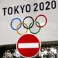 FILE PHOTO: A banner for the upcoming Tokyo 2020 Olympics is seen behind a traffic sign, following an outbreak of the coronavirus disease (COVID-19), in Tokyo, Japan, March 23, 2020. REUTERS/Issei Kato -/File Photo