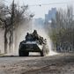 Service members of pro-Russian troops ride an armoured personnel carrier during Ukraine-Russia conflict in the southern port city of Mariupol, Ukraine April 15, 2022. REUTERS/Alexander Ermochenko