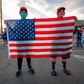 Supporters of US President Donald Trump hold a US flag as they gather to protest outside the Maricopa County Election Department as counting continues after the US presidential election in Phoenix, Arizona, on November 5, 2020. - President Donald Trump erupted on November 5 in a tirade of unsubstantiated claims that he has been cheated out of winning the US election as vote counting across battleground states showed Democrat Joe Biden steadily closing in on victory. (Photo by OLIVIER TOURON / AFP)