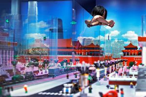 A woman takes a photo of the Forbidden City model as a glass panel reflecting the skyscrapers at the Central Business District and the Great Wall of China, all made of Lego bricks, on display at a newly opened Legoland Discovery Center in Beijing, Monday, April 22, 2019. The Legoland Discovery Center offering children and parents a sneak peek of miniatures showcases the major landmarks from historical sites to iconic skyscrapers in the capital city. (AP Photo/Andy Wong)