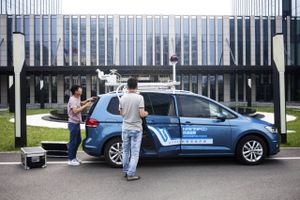 Employees prepare a NavInfo vehicle mounted with a lidar sensor, left, and a unit comprised of 360-degree cameras for data collection in Beijing on June 11, 2018. MUST CREDIT: Giulia Marchi/Bloomberg