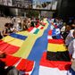 Et 30 meter langt ukrainsk flag, omgivet af EU-landenes flag, blev torsdag foldet ud foran Europa-Parlamentet, hvor et stort flertal opfordrede til, at Ukraine får kandidatstatus. Det støtter statsminister Mette Frederiksen også, og hun forudser, at landet en dag bliver medlem af EU. Foto: Yves Herman/Reuters